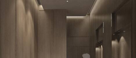 A modern elevator interior with wood paneling and a marble floor.