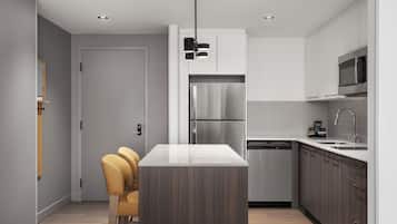 Une cuisine moderne dotée d’un îlot central, d’appareils électroménagers en acier inoxydable et d’un design minimaliste.