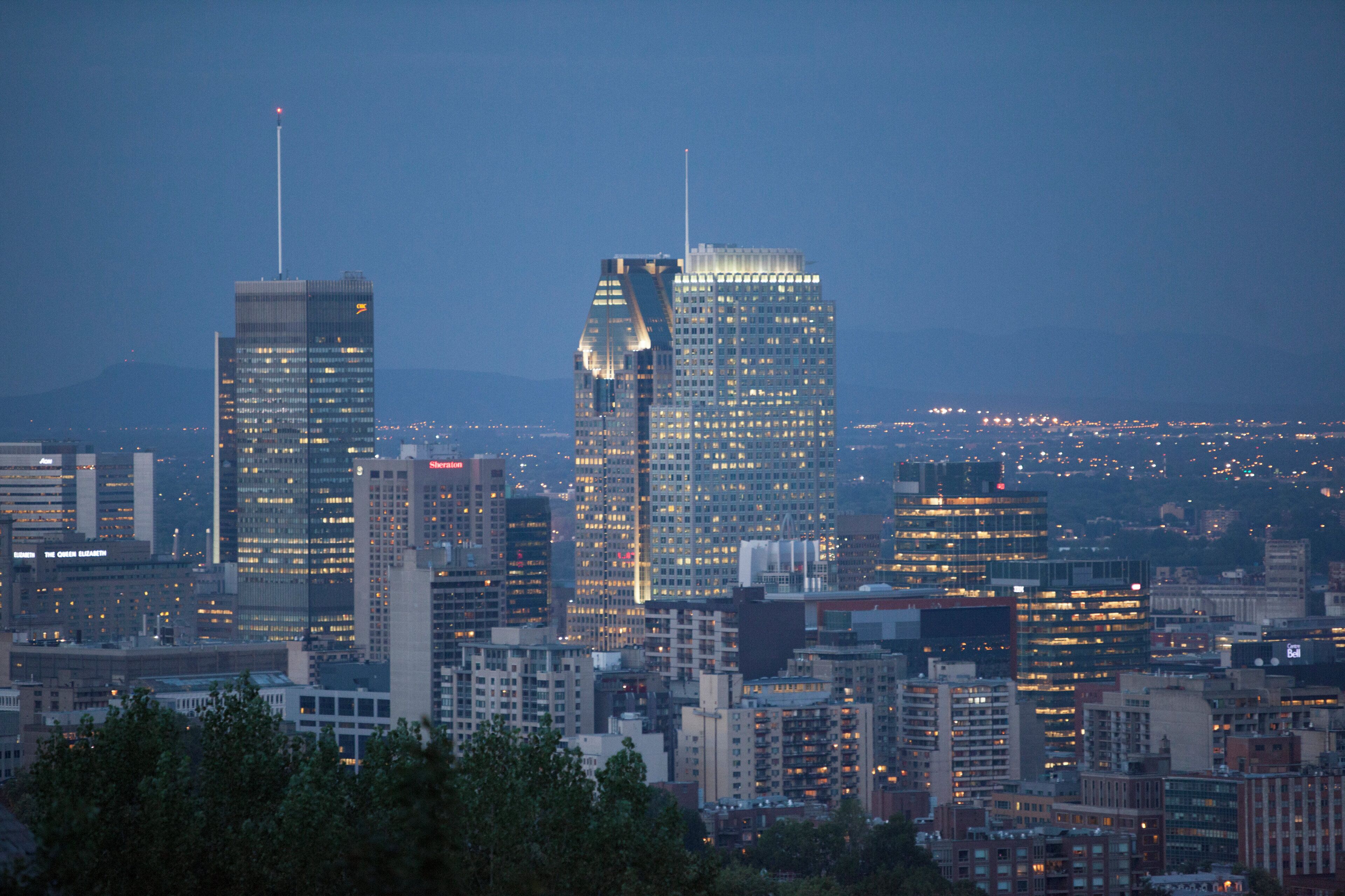 A cityscape with high-rise buildings, including a distinctive skyscraper with a unique architectural design.