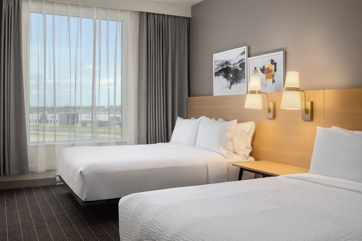 Premium bedding, pillow-top beds, desk, laptop workspace