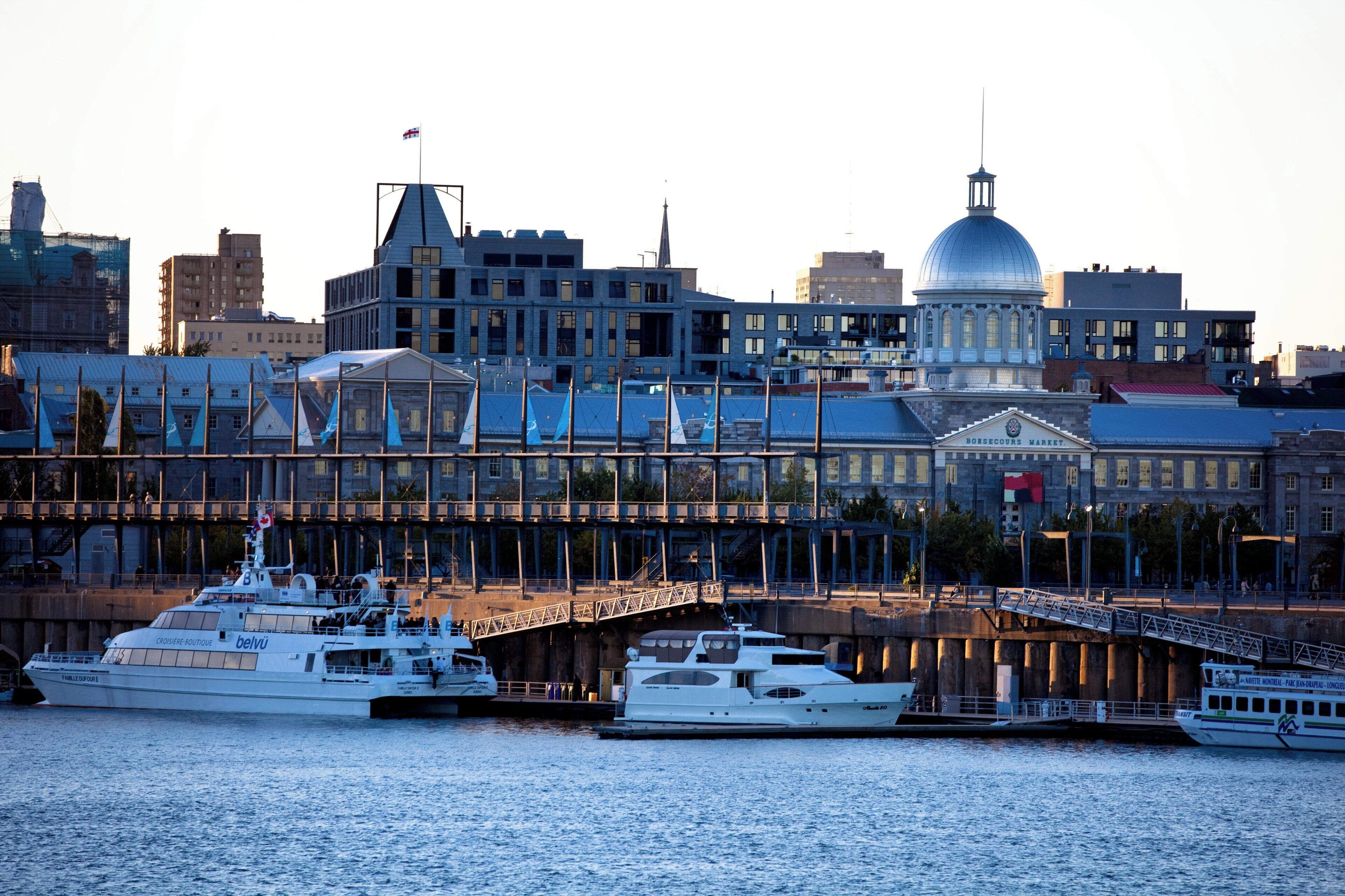 A waterfront cityscape with a prominent dome and a bridge.