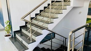 A modern staircase with metal railings and granite steps.