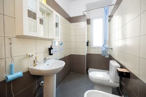 A bathroom with a sink, toilet, and shower area. - Vlora Promenade Studio | 3-5 Guests | Beach Access (Valona)