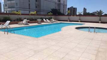 Outdoor pool, open 9:00 AM to 8:00 PM, pool umbrellas, pool loungers