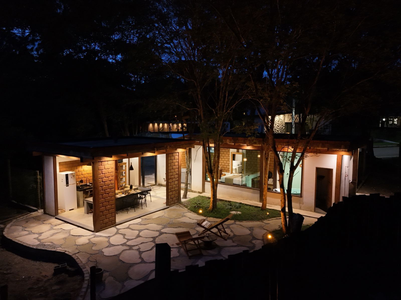 A modern house with a patio, a dining area, and a visible kitchen.