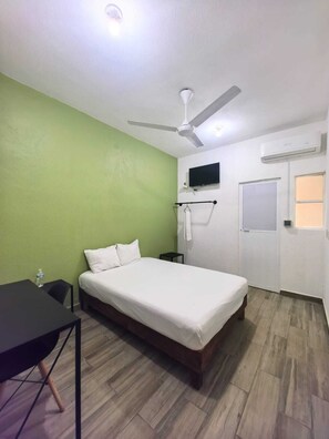 Relax in this stylish room with a single bed, ceiling fan, and flat-screen TV.