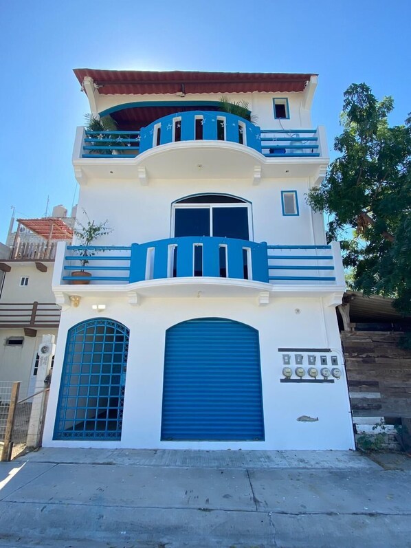 Stunning multi-story building with a balcony and arched entrance.