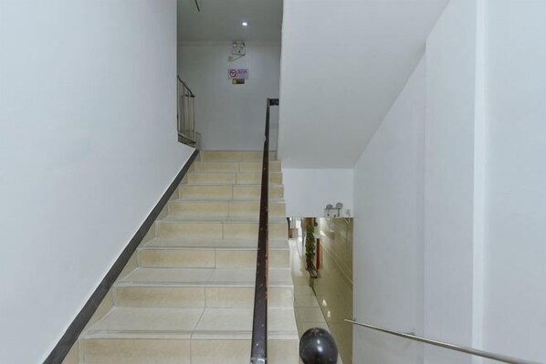 A staircase with a handrail, a 'No Smoking' sign, and a wall-mounted light fixture. - Hengbo Hotel (Shanghai)