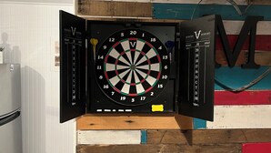 A dartboard mounted on a wall with a colorful wooden panel design. - 2-bedroom mobile home in enchanting Havasu Lake with WiFi, AC (Havasu Lake)