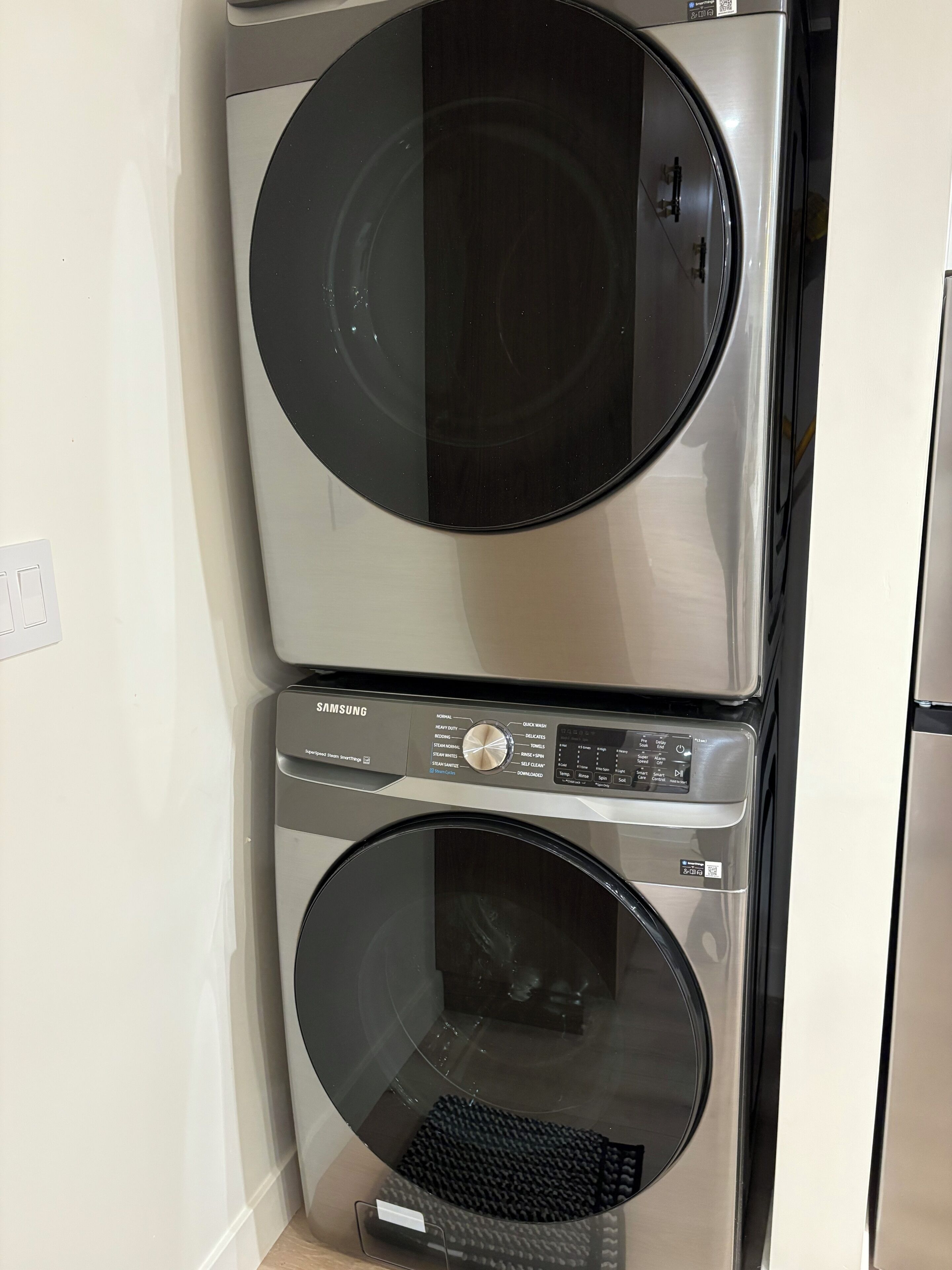 A Samsung front-loading washer and dryer stacked vertically.