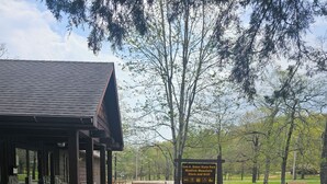 A park entrance with a sign for Sam A. Baker State Park and Mudlick Mountain Store and Grill. - Sam A Baker State Park (Patterson)