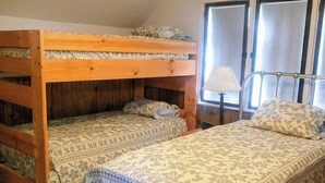 A room with two bunk beds, a single bed, a ceiling fan, and a window with blinds. - Sam A Baker State Park (Patterson)
