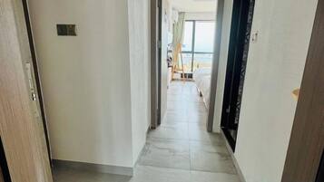 Un pasillo que conduce a una habitación con cama y vistas al mar.