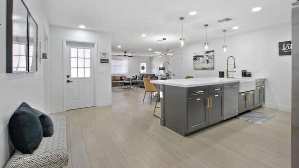 A modern kitchen with grey cabinets, a central island, and pendant lighting. - Perfect for Large Group  5BD+3BA Free Parking (Mesa)
