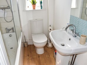 A bathroom with a toilet, sink, and shower. - 2 bedroom accommodation in Ventnor (Ventnor)
