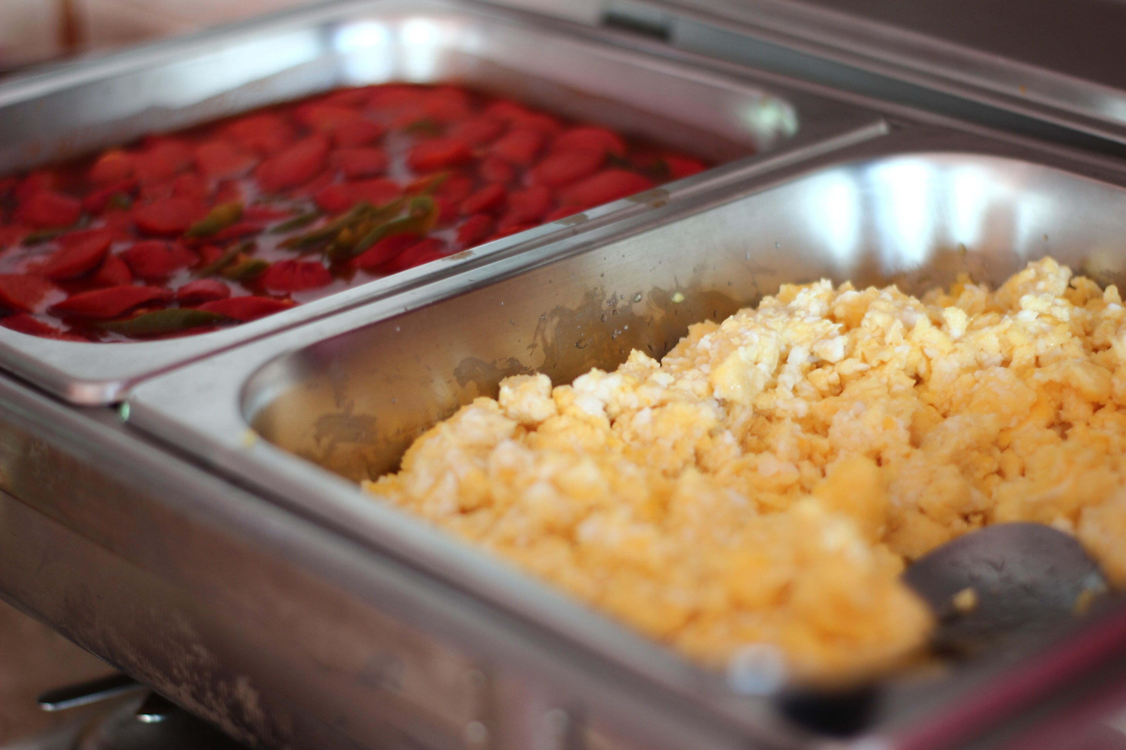 A buffet with two sections: one with red items and another with yellow items.