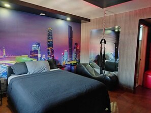 A modern hotel room with a large bed, a massage chair, and a cityscape mural on the wall. - LIZVAN HOTEL MOTEL (Tijuana)