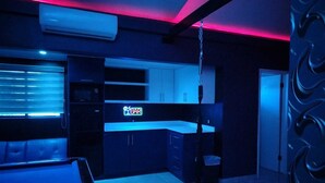 A modern kitchen with a neon sign reading "YBAR" and a hanging light fixture. - LIZVAN HOTEL MOTEL  (Tijuana)