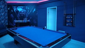 A pool table in a room with a blue hue and pink neon lighting. - LIZVAN HOTEL MOTEL  (Tijuana)