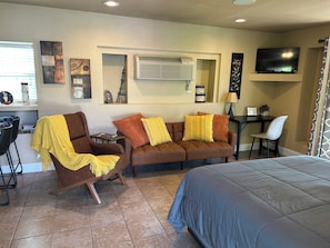 A furnished room with a sofa, armchair, and a bed. - Cozy one room suite with WiFi close to NOC , downtown Tonkawa and casinos. (Tonkawa)