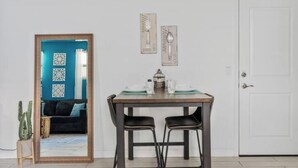A dining area with a wooden table, two black chairs, and a white door in the background. - Private Entry Guest Suite by AZ Athletic Grounds - 1 BD + 1 BA - Sleeps 4 (Mesa)