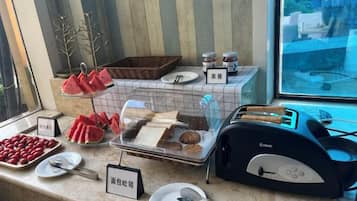 A breakfast buffet with various food items and a toaster.