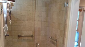 A bathroom with a shower, a sink with a mirror, and a towel rack. - Safe & beautiful new studio in charming Sherman Oaks neighborhood (Los Angeles)