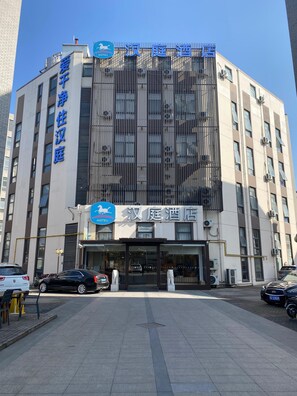 A hotel with a modern facade, large windows, and a prominent entrance.