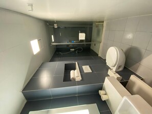 A modern bathroom with a toilet, bidet, and hand dryer. - Hanting Hotel Shanghai Anting Car City (Shanghai)