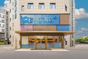 A hotel with a modern facade, large glass entrance, and a prominent sign. - HanTing Hotel (Shanghai Anting Auto City) (Shanghai)