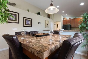 Enjoy meals in this cozy dining area with a marble table and comfortable leather chairs.