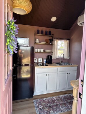 Fridge, microwave, coffee/tea maker, cookware/dishes/utensils