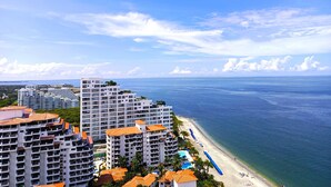 A beachfront hotel with multiple buildings, a pool, and a beach with umbrellas. - VIP Apartment - With Sea and Beach View (Santa Marta)
