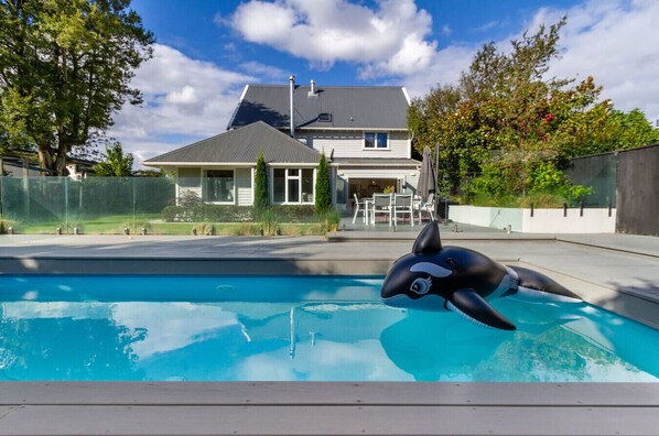 Une piscine équipée d’un dispositif flottant en forme de dauphin.