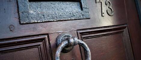 A door with a metal mail slot and a number '73' above it.