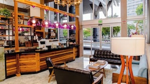 A modern interior with a wooden counter, leather seating, and large windows. - ICON W BRICKELL RENTALS SLEEK STUDIO #2005 (Miami)