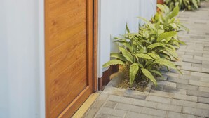 A row of wooden doors with a sign reading "NO 01" on a building facade. - Elite Maya Spa  (Antigua Guatemala)