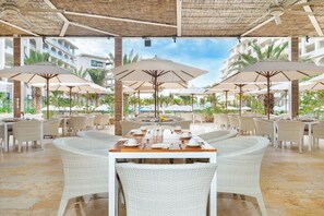 Relax in style with comfortable wicker chairs and tables set amidst lush surroundings.