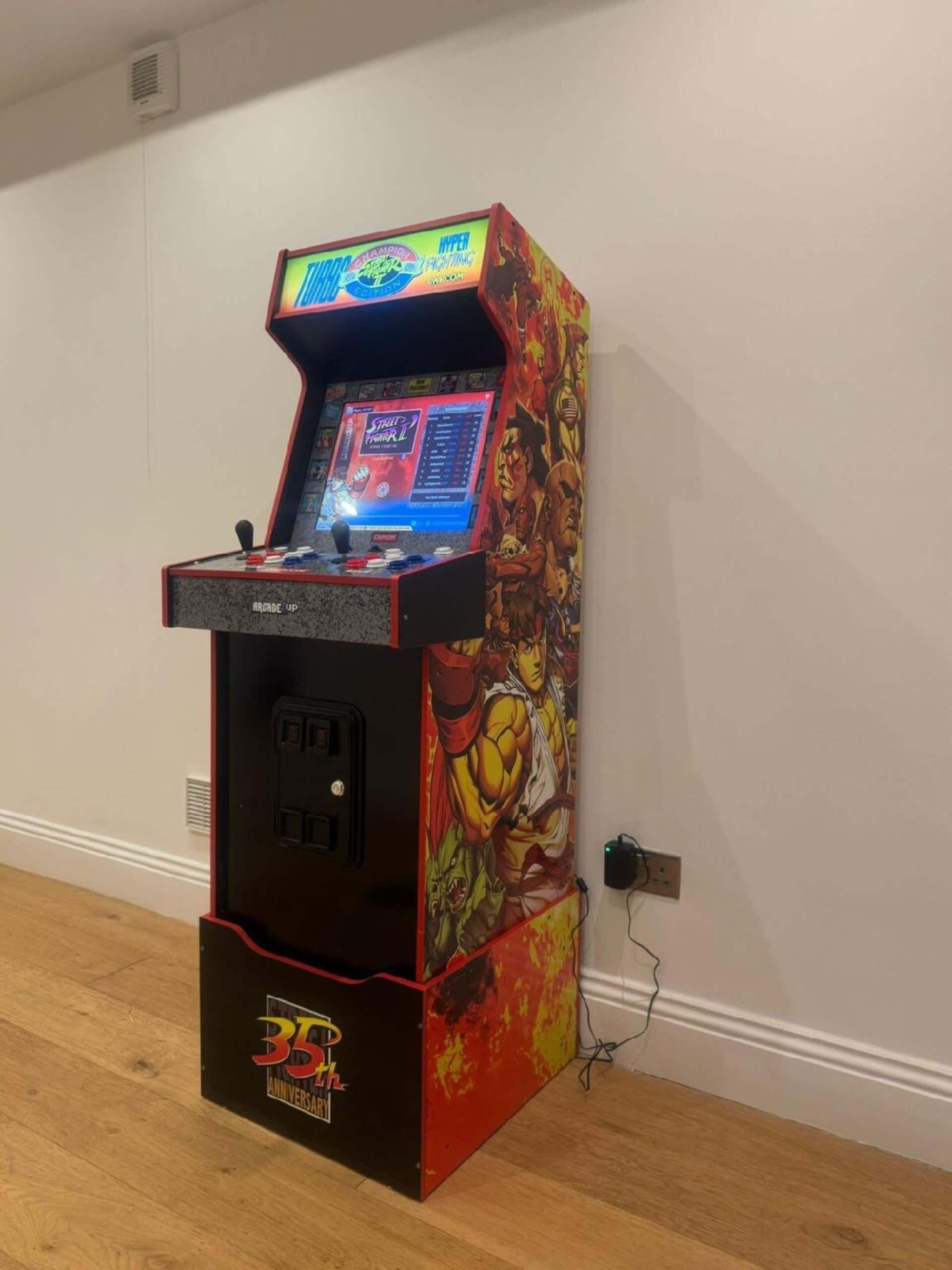 A retro arcade machine with a screen, joystick, and buttons, featuring a 35th anniversary design.