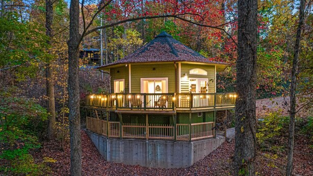 A wooden cabin with a balcony, surrounded by trees and autumn leaves. - Play Arcade Games, Make Firepit S'mores & Explore Downtown Blue Ridge in Minutes - Trails End (Blue Ridge)
