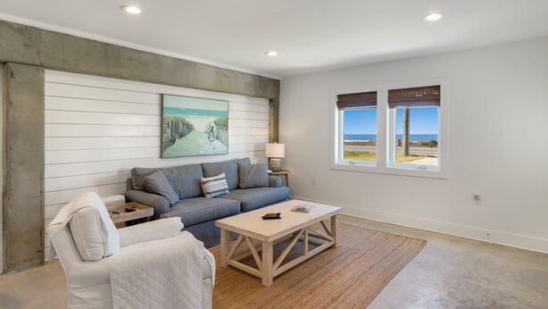 A modern living room with a sofa, a coffee table, and a painting on the wall. - "Salt Therapy" offers gulf views, 100 steps to beach, modern 2BD/2BA, single level! (Port Saint Joe)
