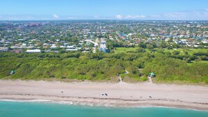 An aerial view of a coastal town with a beach, residential areas, and a golf course. - Stylish 2BR, 2BA Apartment with Balcony & Pool - Just Steps from the Beach (Boca Raton)