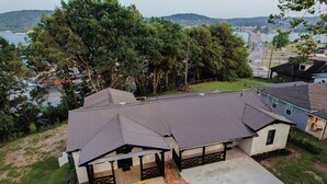 A residential property with a large garage, a covered patio, and a view of a lake and mountains.