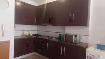 Fridge, microwave, coffee/tea maker, cookware/dishes/utensils