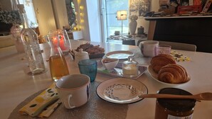 A table set with food, drinks, and a candle, suggesting a dining area. - Guest Room 'Magnolia' with Shared Pool, Shared Terrace, and Wi-Fi (Arzano)