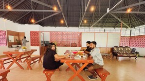 A spacious dining area with high ceilings and exposed beams, featuring wooden tables and benches. - Domestay with Mountain View - Gateway of Munnar (Munnar)