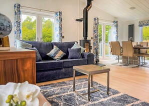 A modern living room with a sofa, a coffee table, and a fireplace. - 1 bedroom accommodation in Chipping (Chipping)