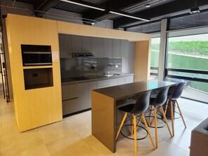 Business Apartment | Private kitchen | Full-size fridge, microwave, stovetop, coffee/tea maker