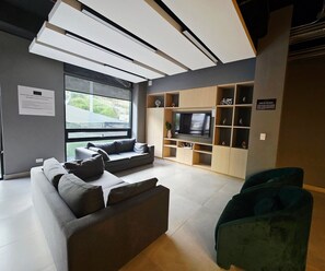 Business Apartment | Living area | 50-inch flat-screen TV with satellite channels