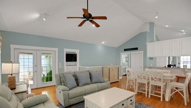 A spacious living room with a sofa, coffee table, and dining area. - Steps2Beach~Heated Pool~MiniGolf~Hot Tub~Game Room (Panama city)